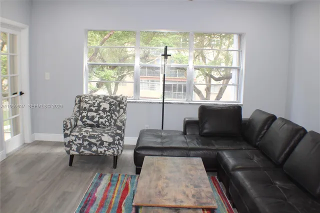a living room with furniture and a large window