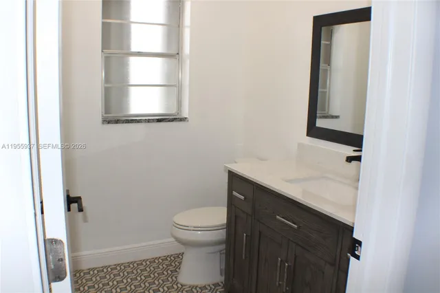 a bathroom with a toilet sink and window
