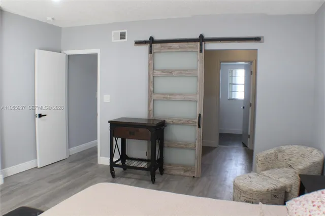 a bedroom with furniture and a window