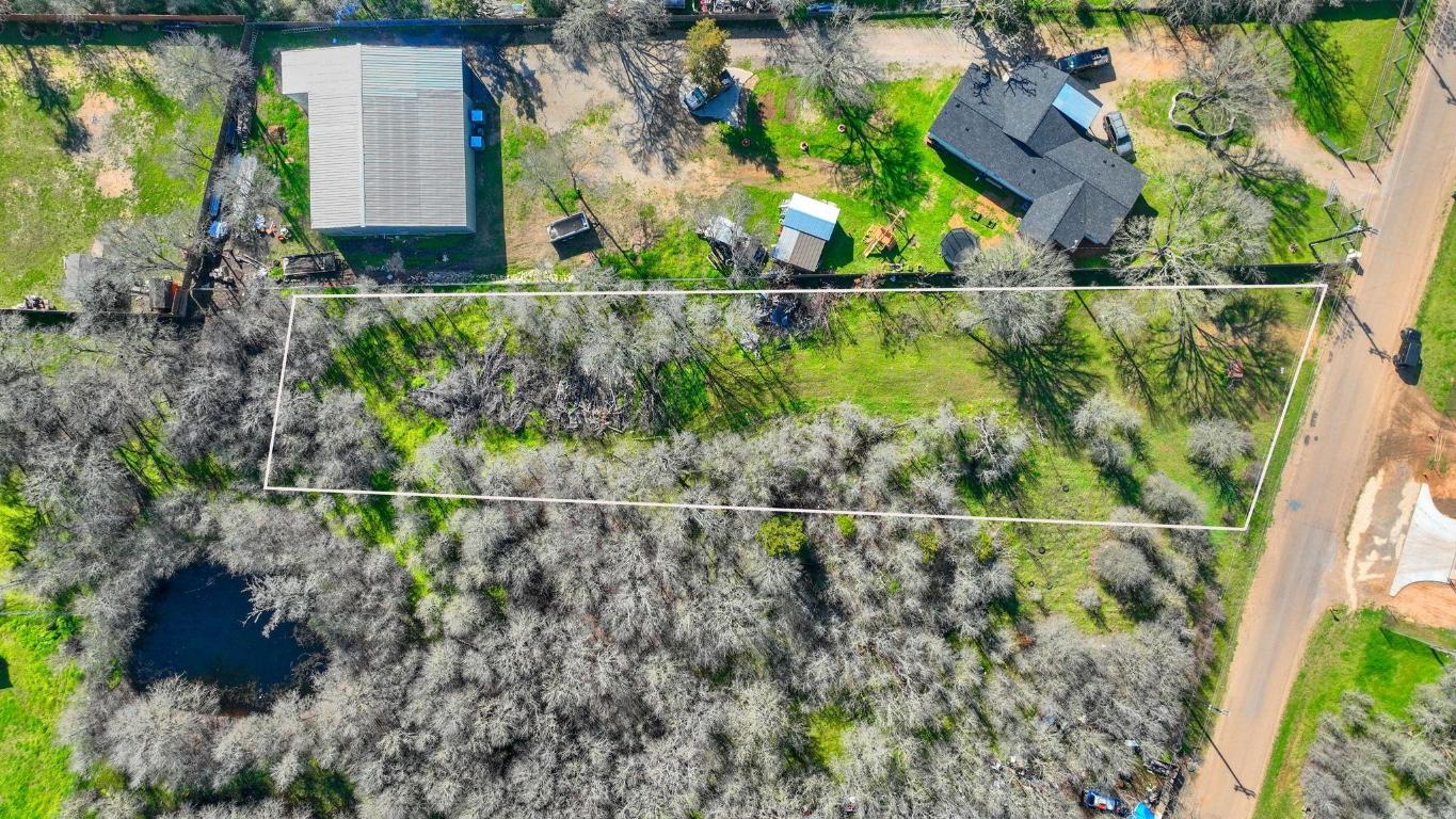 an aerial view of a house with a yard and lake view