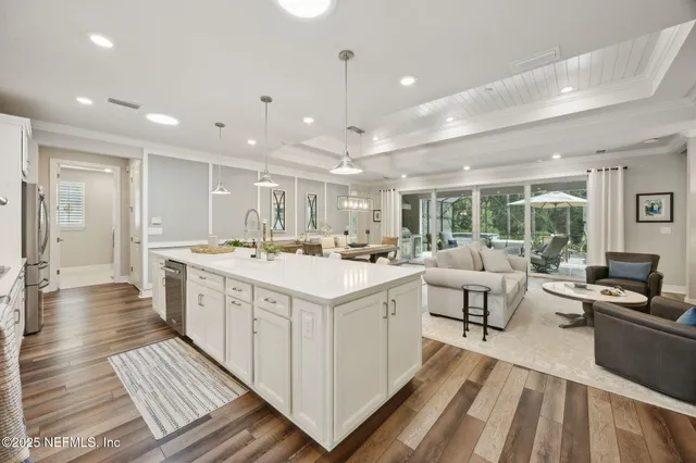 a living room with furniture large window and flat screen tv