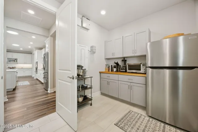 an aerial view of residential houses with outdoor space and trees