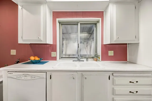 a kitchen with a sink and cabinets