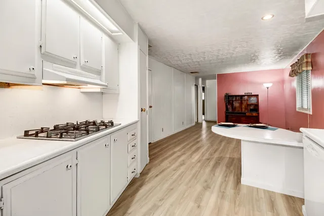 a kitchen with stainless steel appliances a stove a sink and a refrigerator