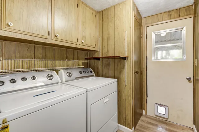 a view of a house with a floor to ceiling window and yard