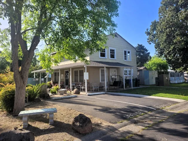 a view of a house with backyard sitting area and garden