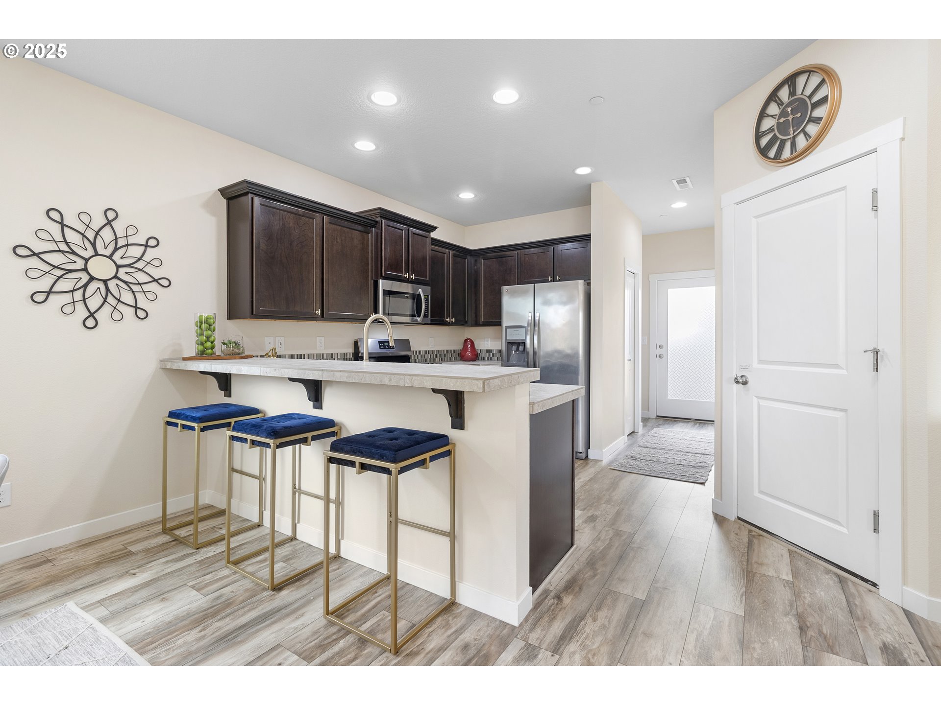 7417 North 92nd Avenue Camas, WA 98607 - Photo 16 of 48 a kitchen with stainless steel appliances kitchen island granite countertop a refrigerator and a stove top oven