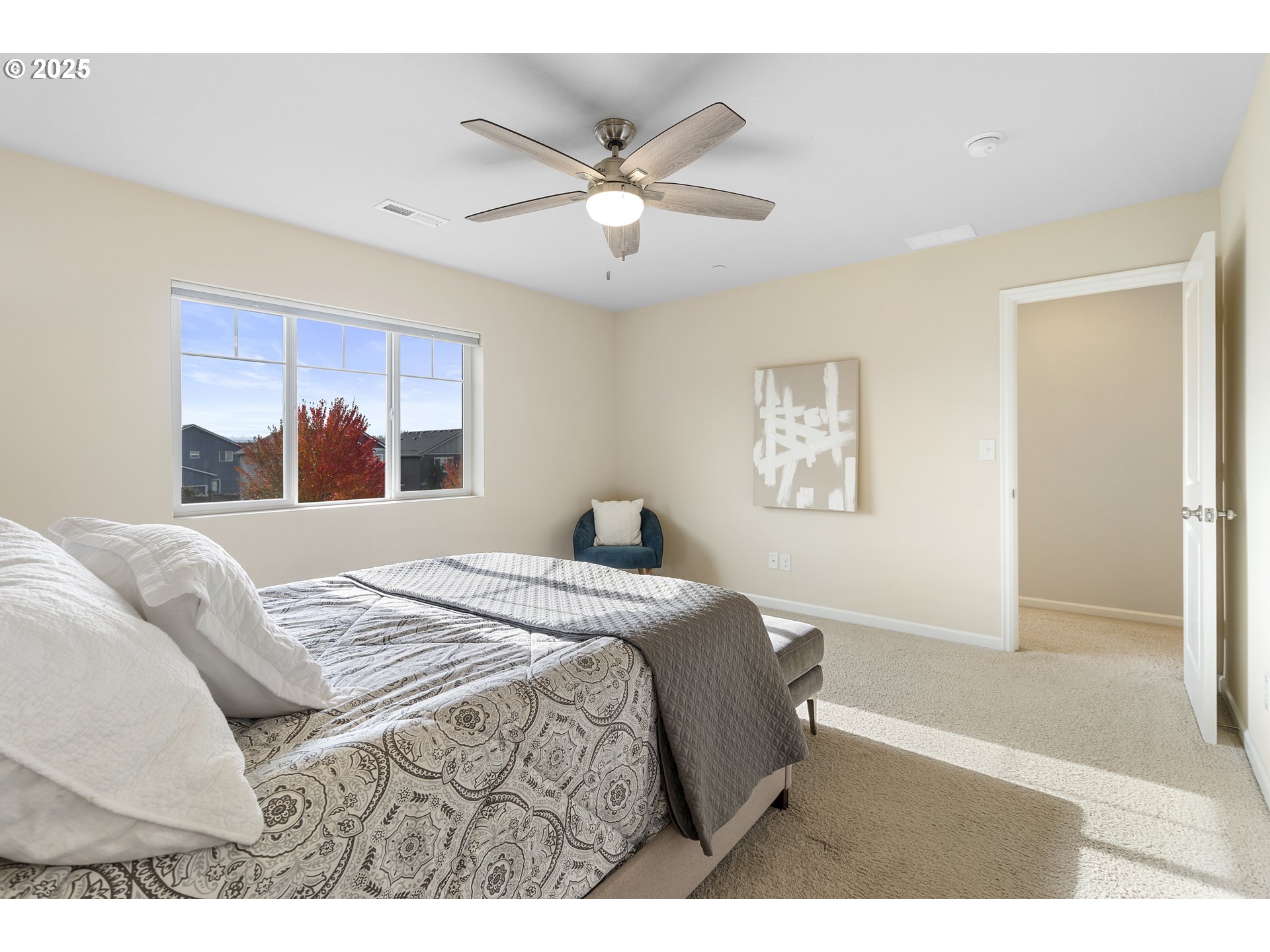 7417 North 92nd Avenue Camas, WA 98607 - Photo 29 of 48 a bedroom with a large bed and a chandelier