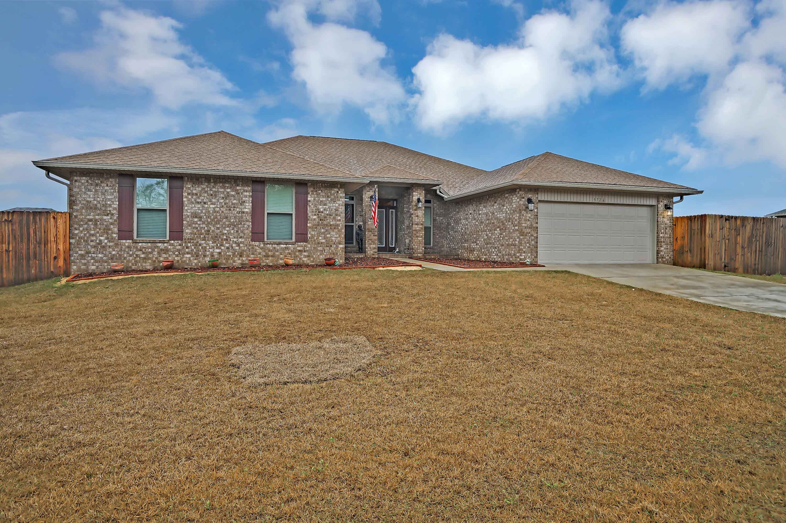 5726 Marigold Loop Crestview, FL 32539 - Photo 1 of 38 a front view of a house with a yard and garage
