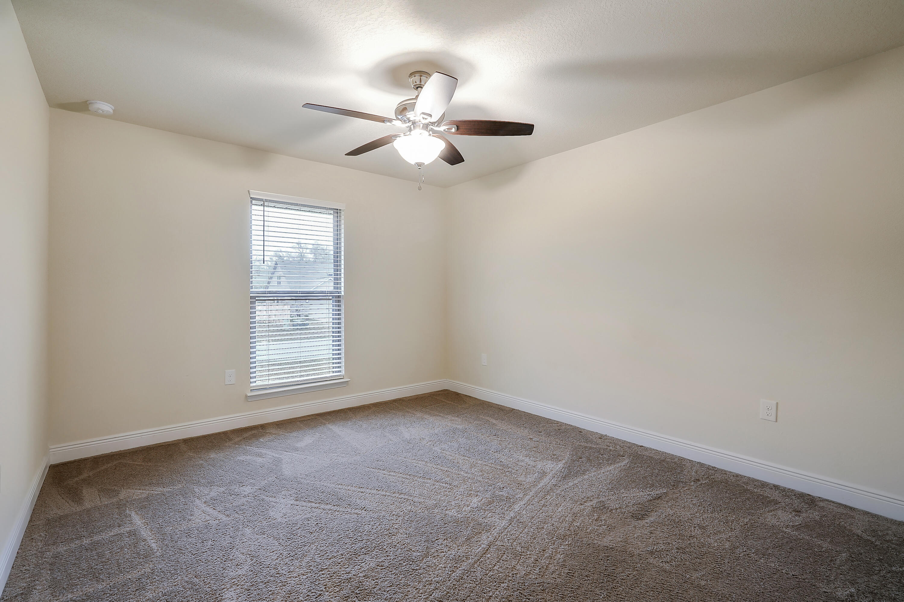 5726 Marigold Loop Crestview, FL 32539 - Photo 33 of 38 an empty room with windows and fan