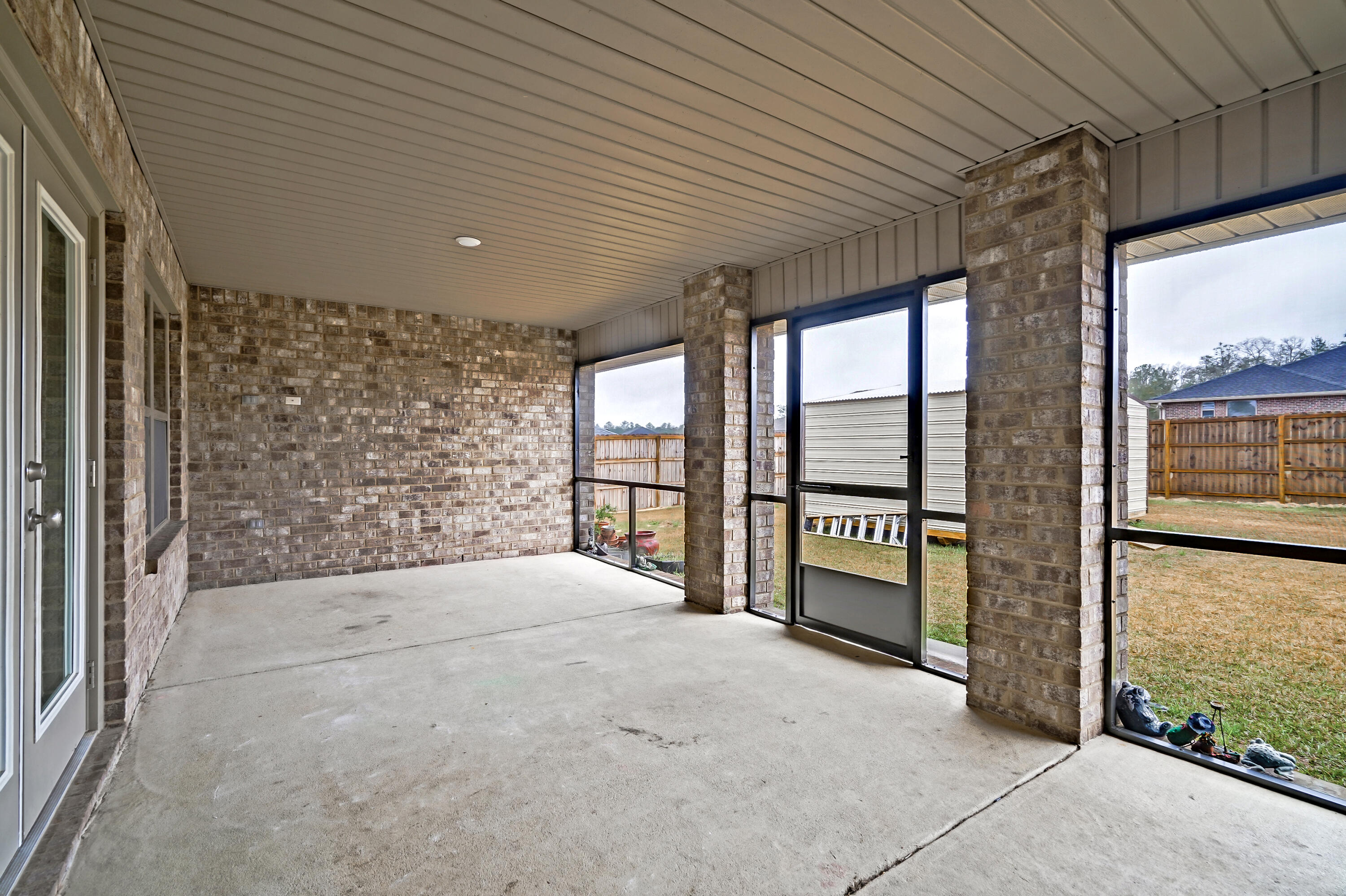5726 Marigold Loop Crestview, FL 32539 - Photo 36 of 38 a spacious bedroom with a large window and a balcony view