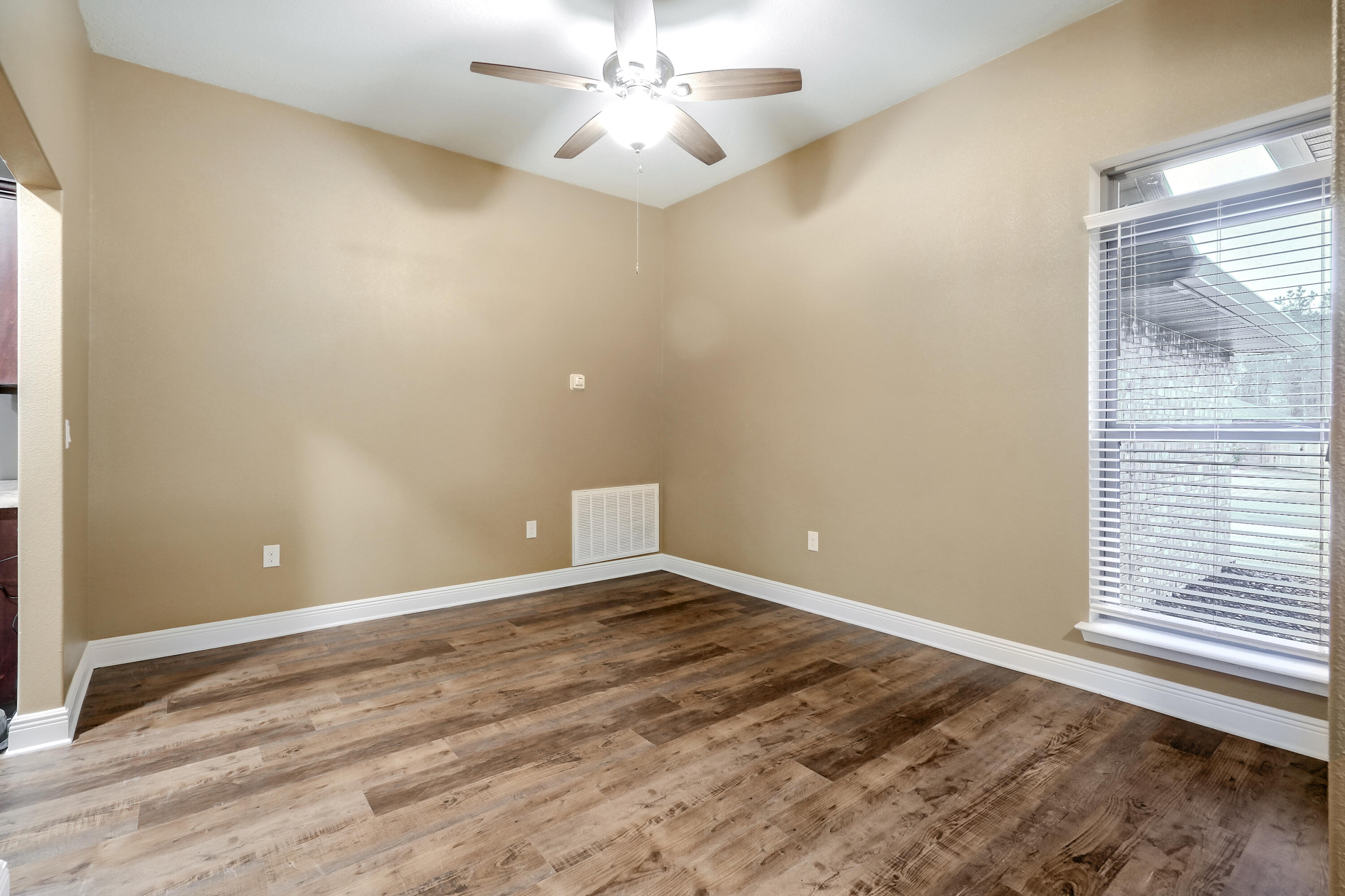 5726 Marigold Loop Crestview, FL 32539 - Photo 6 of 38 an empty room with a window and ceiling fan