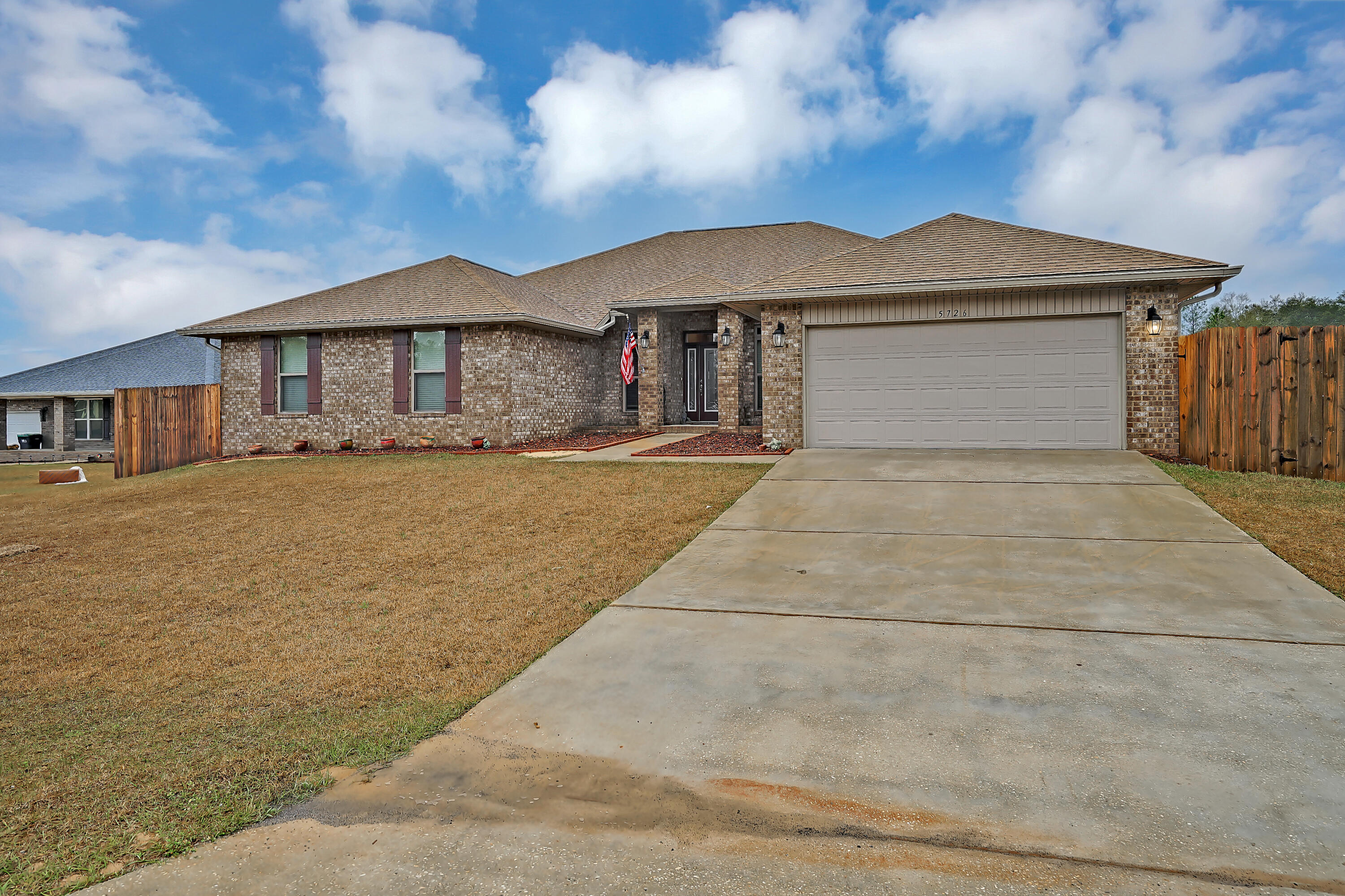 5726 Marigold Loop Crestview, FL 32539 - Photo 7 of 38 a view of a house with a yard and large tree