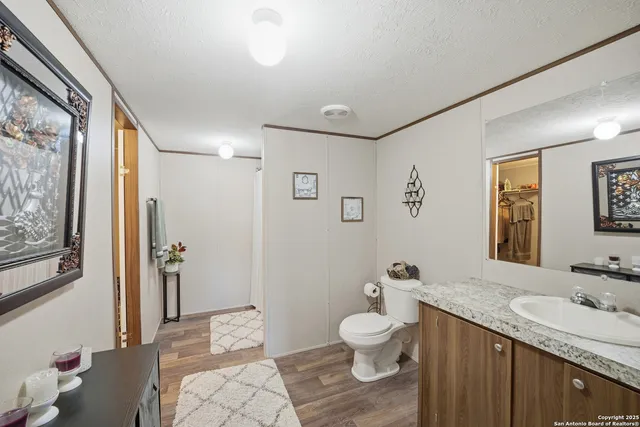 a spacious bathroom with a granite countertop sink toilet and shower