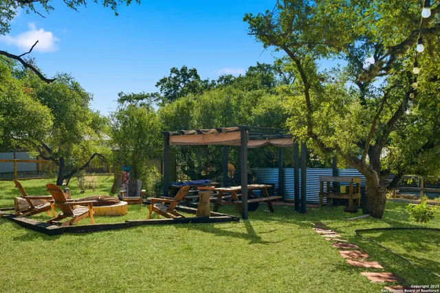 a view of a swimming pool with lawn chairs under an umbrella