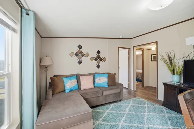 a bedroom with furniture and a flat screen tv
