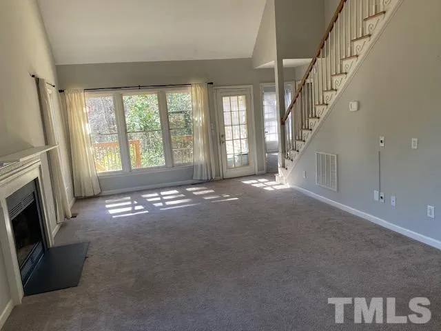 a view of empty room with fireplace and fan