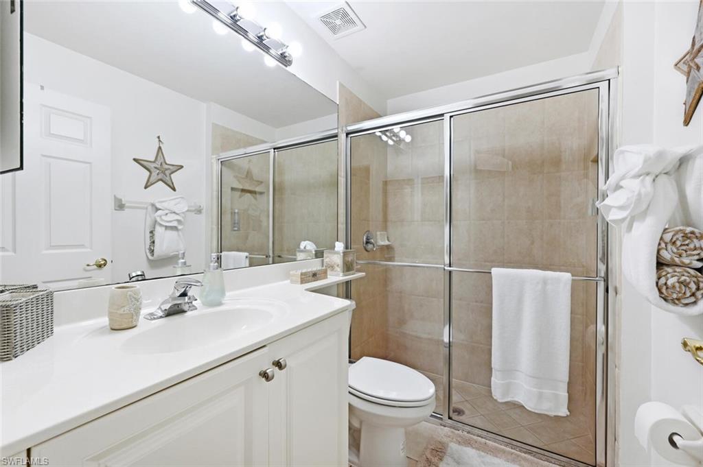 1346 Triandra Lane Naples, FL 34119 - Photo 14 of 19 a bathroom with a sink toilet and shower