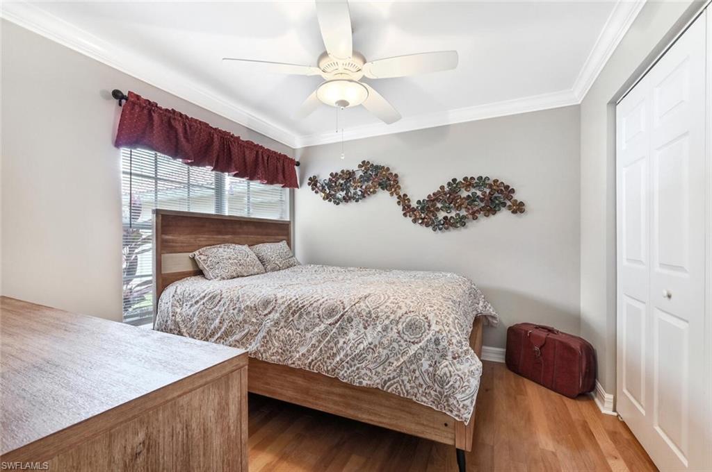 1346 Triandra Lane Naples, FL 34119 - Photo 15 of 19 a bedroom with a bed and a window