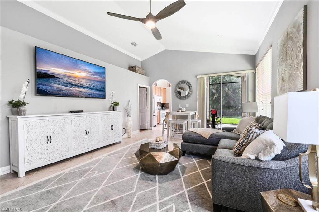 1346 Triandra Lane Naples, FL 34119 - Photo 6 of 19 a living room with furniture and a flat screen tv