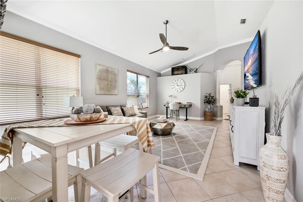 1346 Triandra Lane Naples, FL 34119 - Photo 8 of 19 a view of a dining room with furniture window and wooden floor