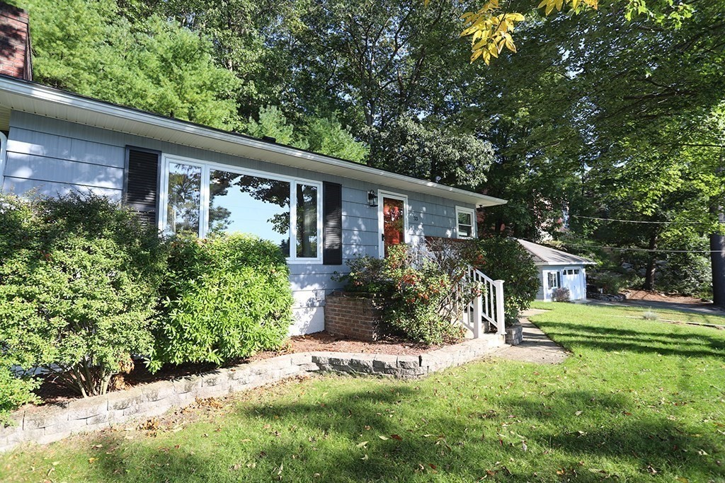 a front view of house with a garden and porch