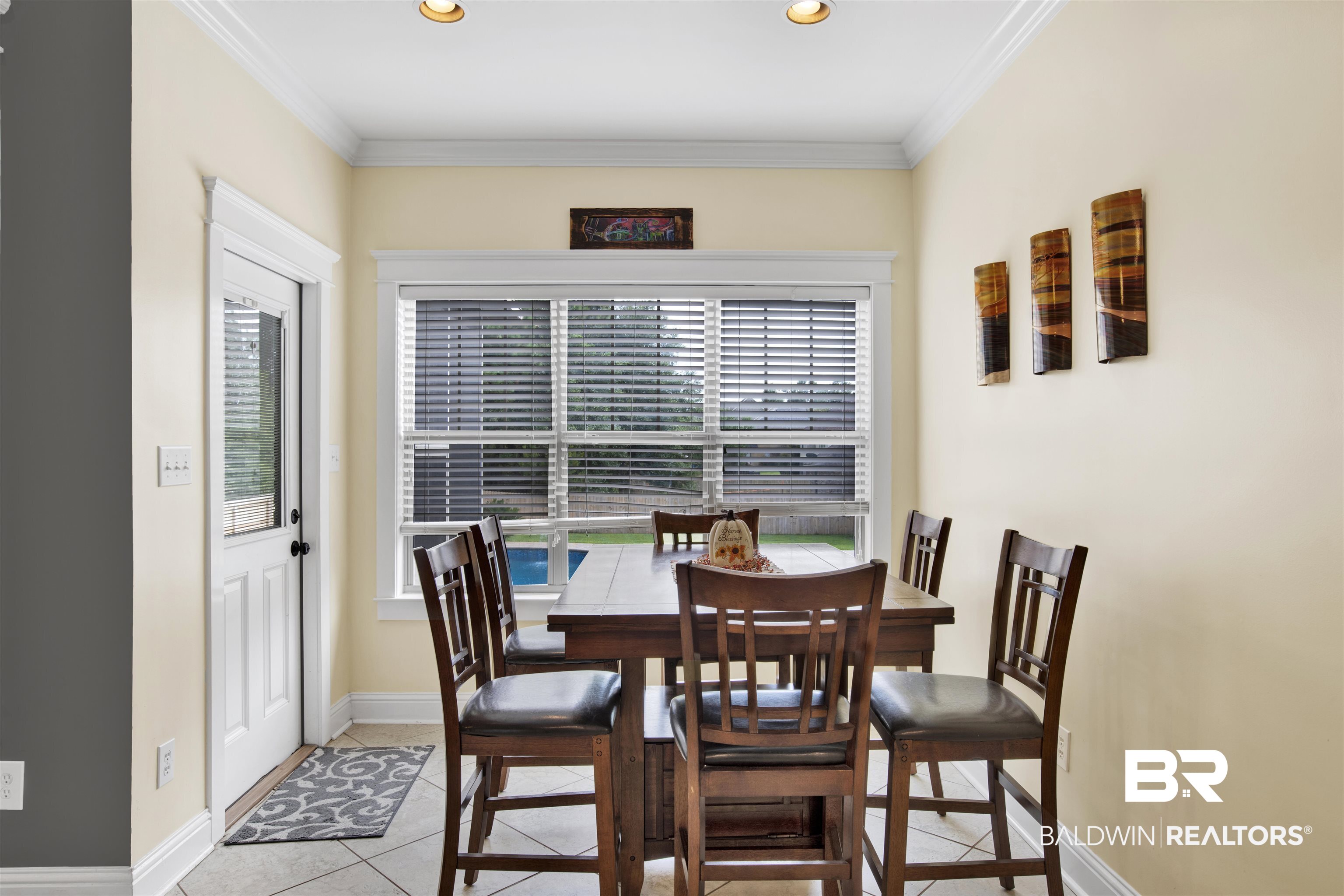 12418 Cambron Trail Daphne, AL 36527 - Photo 23 of 44 Dining area with light tile patterned floors and crown molding