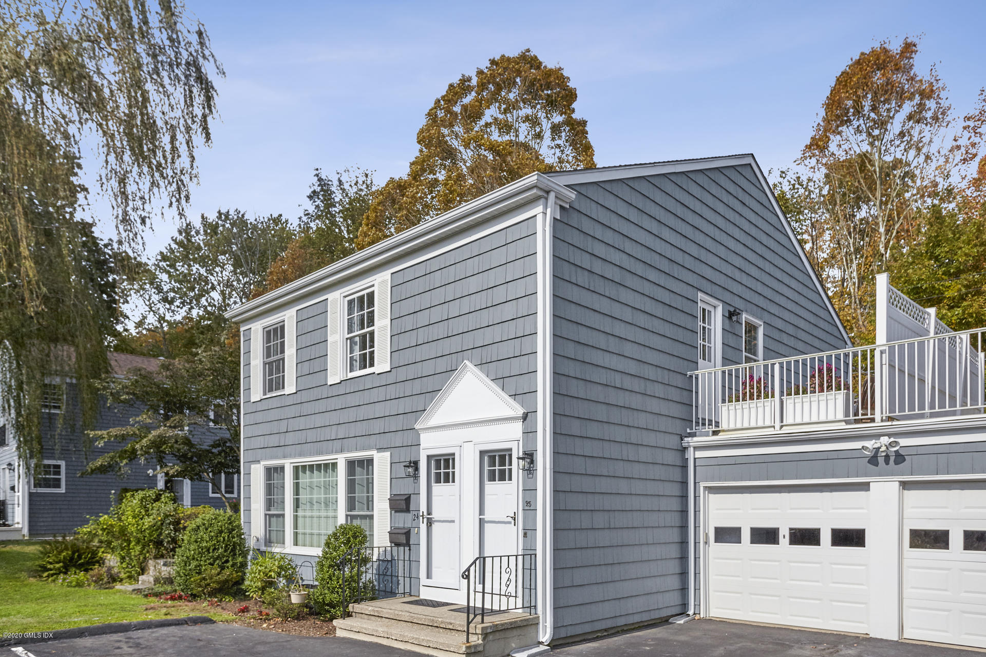102 Valley Road, Unit 25 Cos Cob, CT 06807 - Photo 1 of 21 a front view of a house with a yard