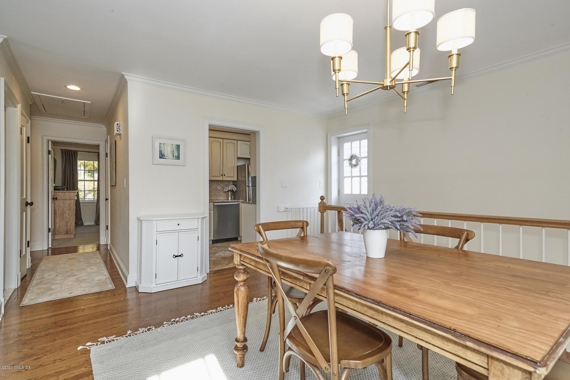 102 Valley Road, Unit 25 Cos Cob, CT 06807 - Photo 11 of 21 a kitchen with a table chairs and chandelier