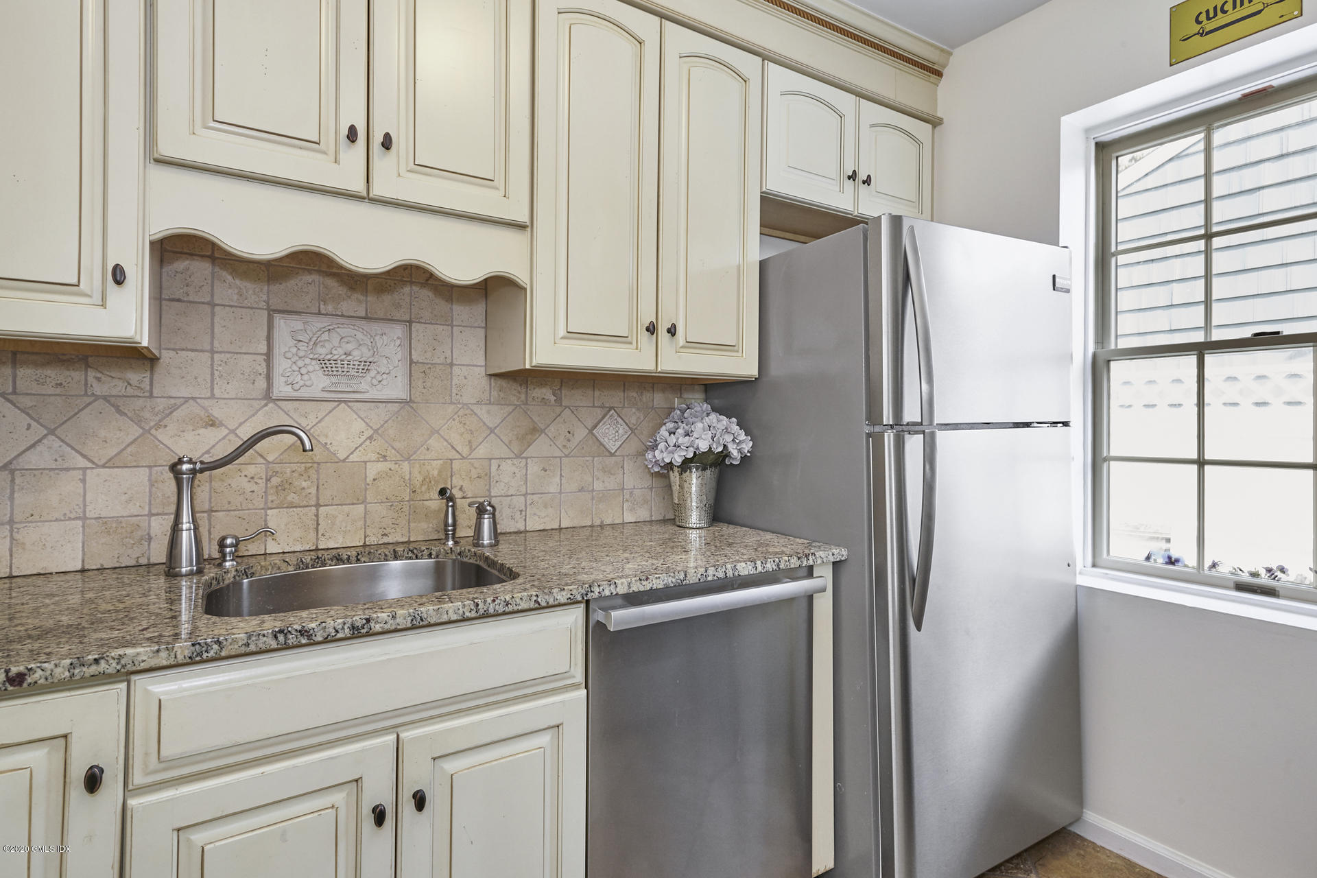 102 Valley Road, Unit 25 Cos Cob, CT 06807 - Photo 18 of 21 a kitchen with granite countertop a refrigerator sink and cabinets