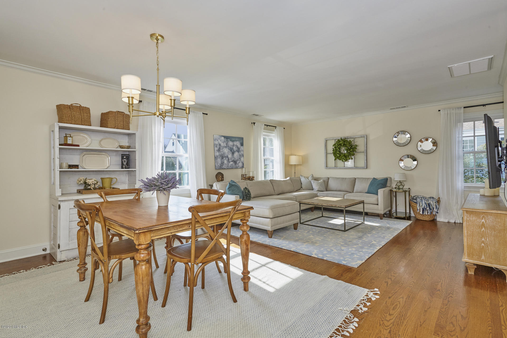 102 Valley Road, Unit 25 Cos Cob, CT 06807 - Photo 7 of 21 a living room with furniture and a chandelier