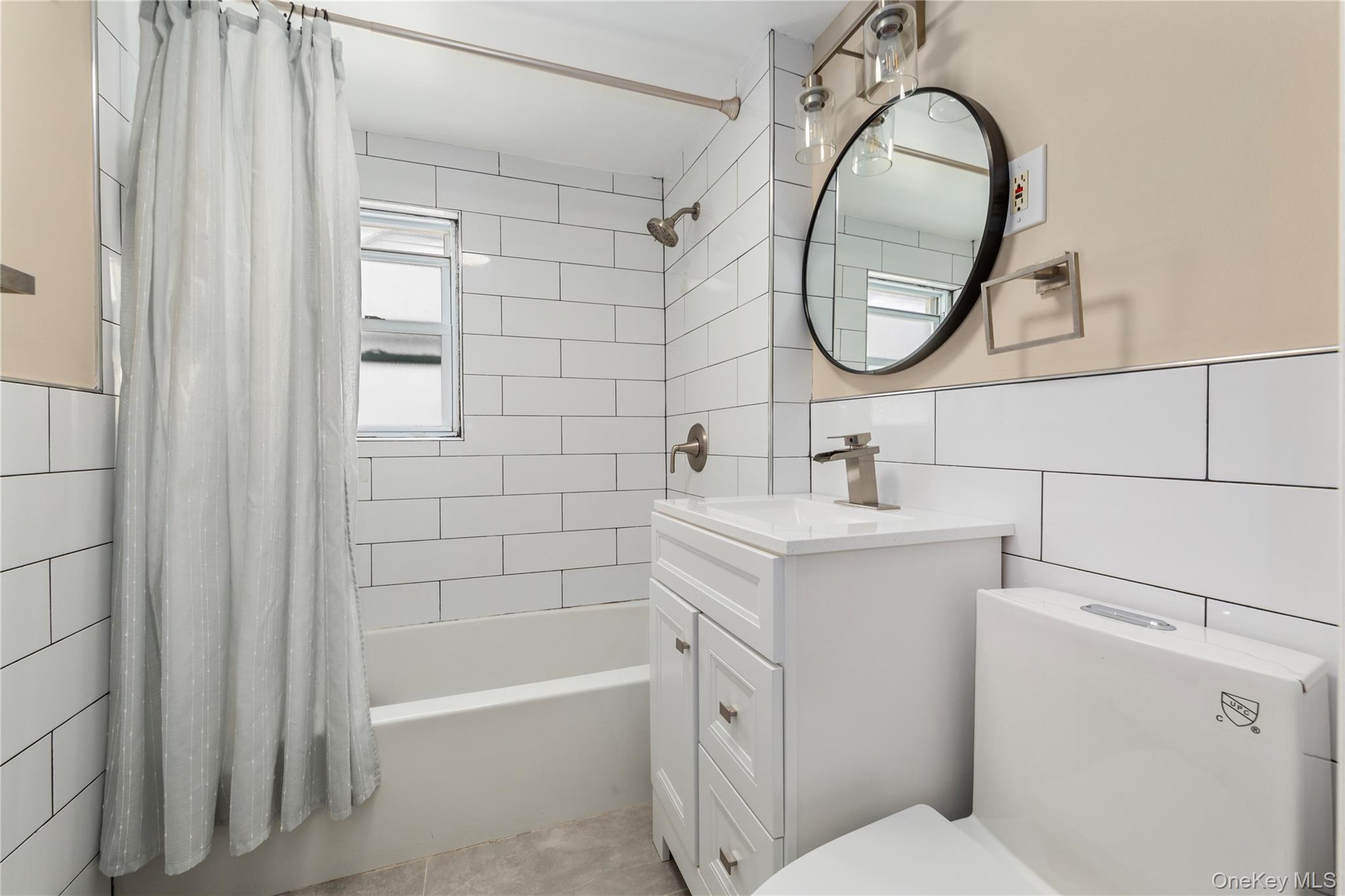 11 Dewitt Street Valley Stream, NY 11580 - Photo 13 of 21 Full bath with tile walls, shower / tub combo, vanity, and light tile patterned floors
