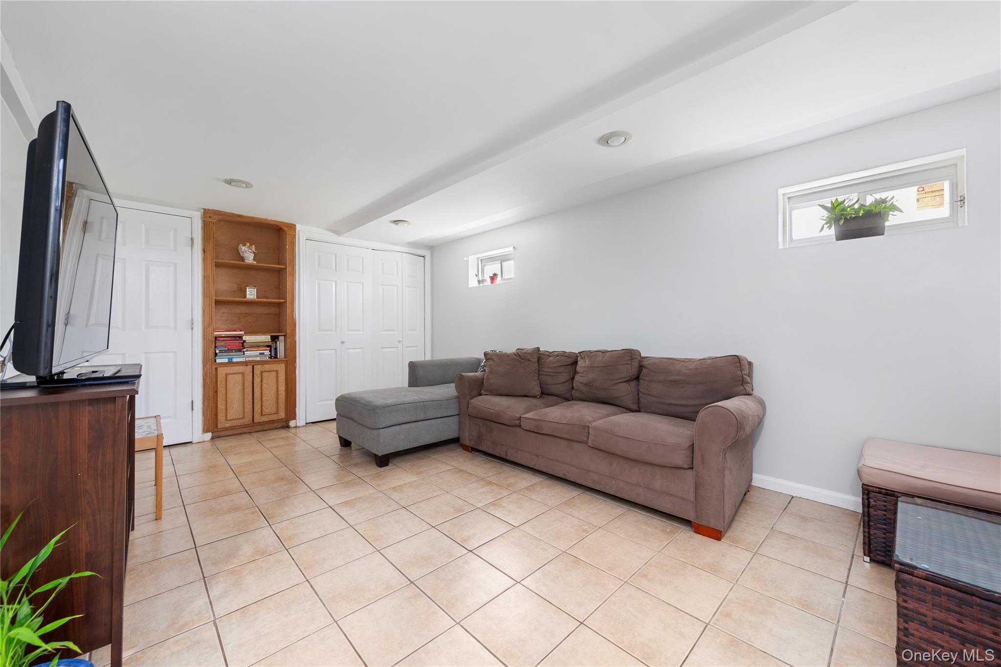 11 Dewitt Street Valley Stream, NY 11580 - Photo 15 of 21 Living room with light tile patterned flooring and baseboards