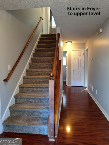a view of an empty room with window and fireplace