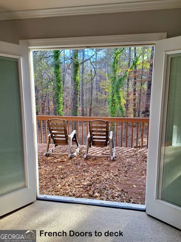 a view of a wooden chairs and bench on the deck
