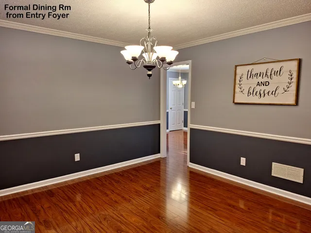 a kitchen with stainless steel appliances granite countertop a stove a sink dishwasher and a microwave oven with wooden floor