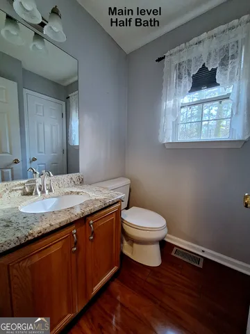 a spacious bathroom with a double vanity sink a mirror and a bathtub