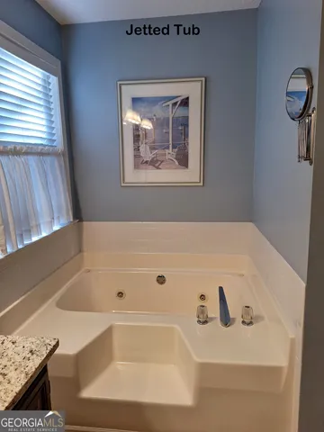 an empty room with closet and a chandelier fan