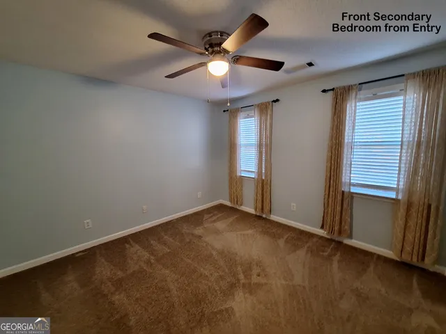 a bathroom with a toilet a sink a window and mirror