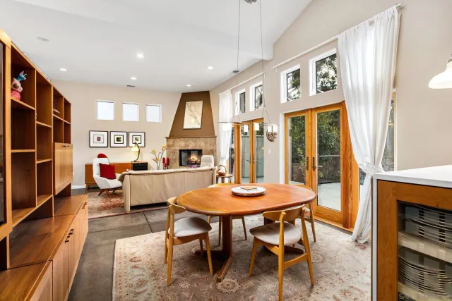 a kitchen with granite countertop white cabinets white appliances a sink and a large window
