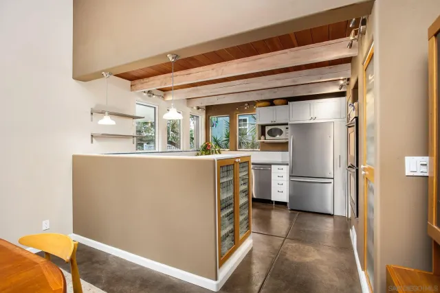 a kitchen with granite countertop white cabinets and window