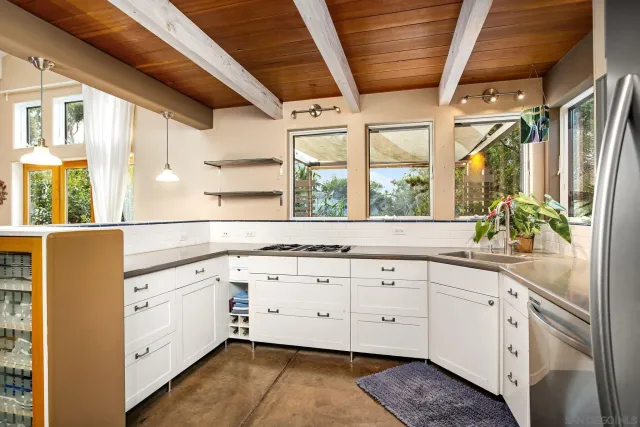 a kitchen with stainless steel appliances a refrigerator and a stove top oven
