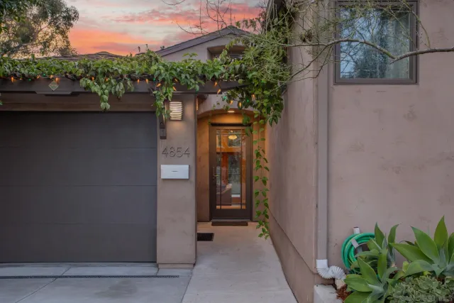 a backyard of a house with plants and tree