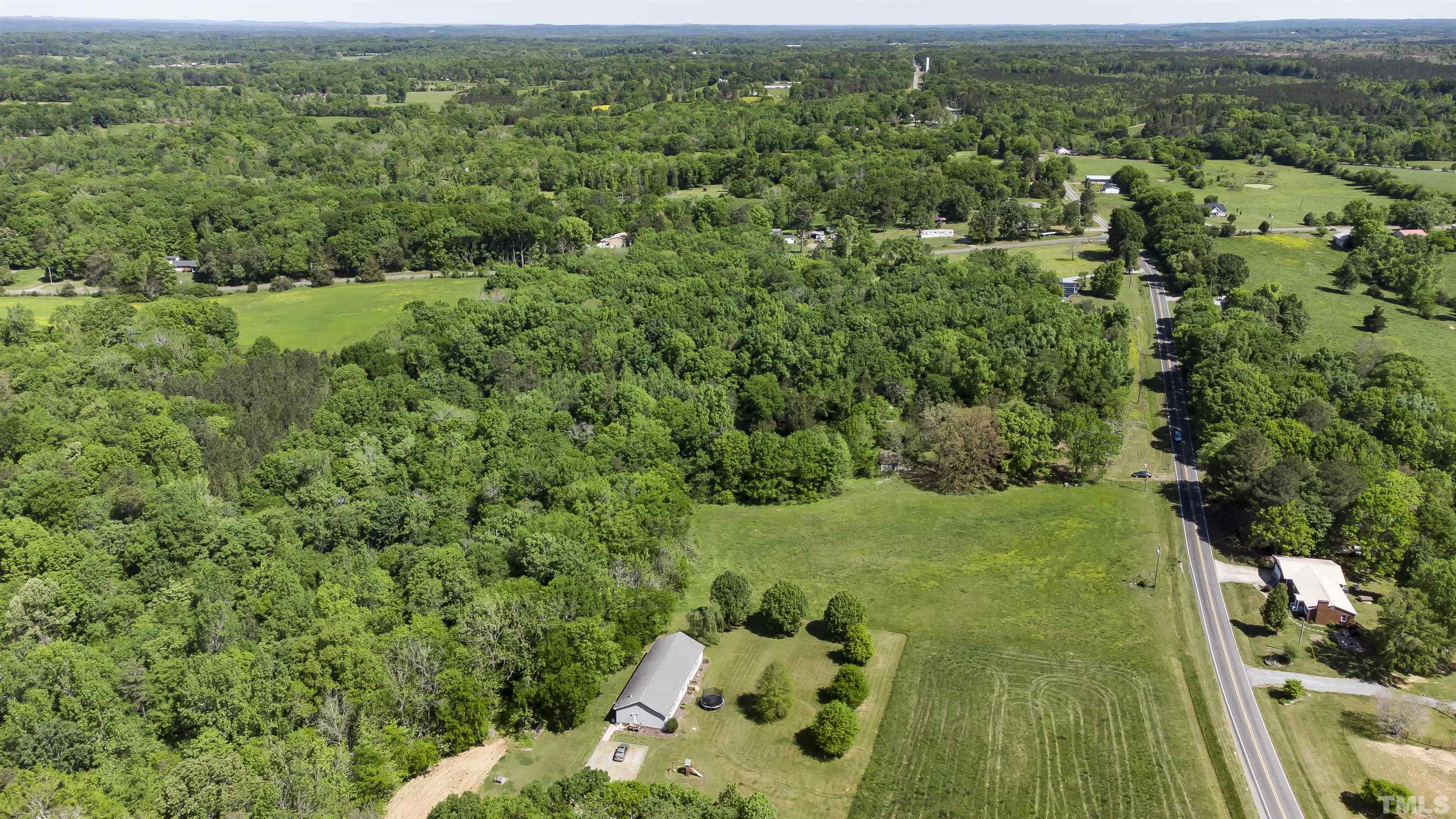 740 Bernard Purvis Road Bennett, NC 27208 - Photo 10 of 23 an aerial view of residential houses with outdoor space and trees