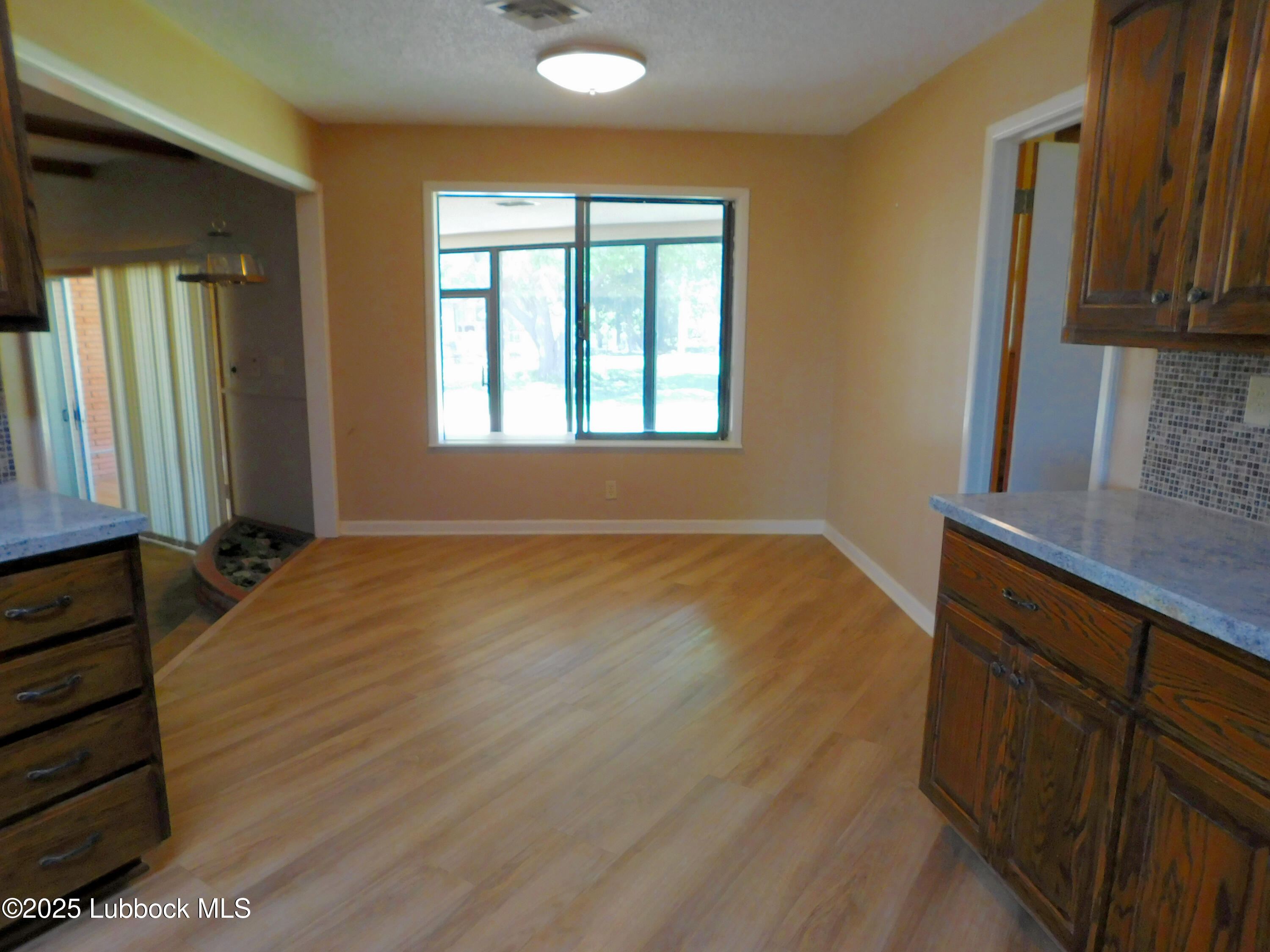 1925 Highway 70 Muleshoe, TX 79347 - Photo 13 of 49 a view of hallway with window and wooden floor
