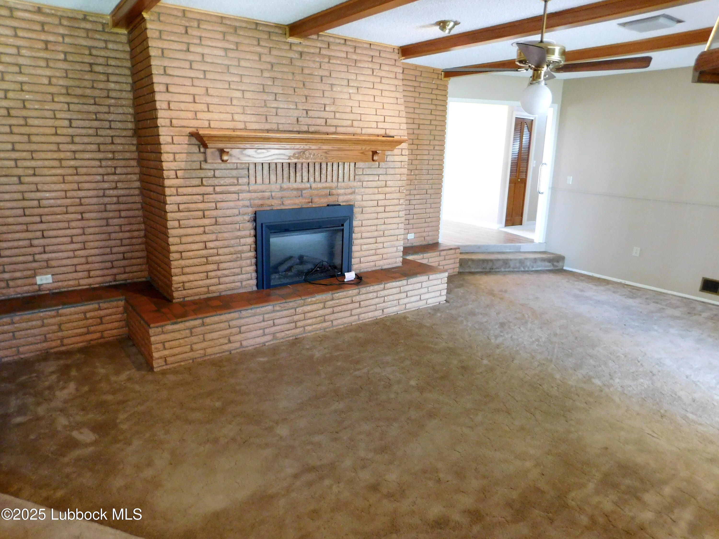 1925 Highway 70 Muleshoe, TX 79347 - Photo 16 of 49 a view of an empty room with a fireplace