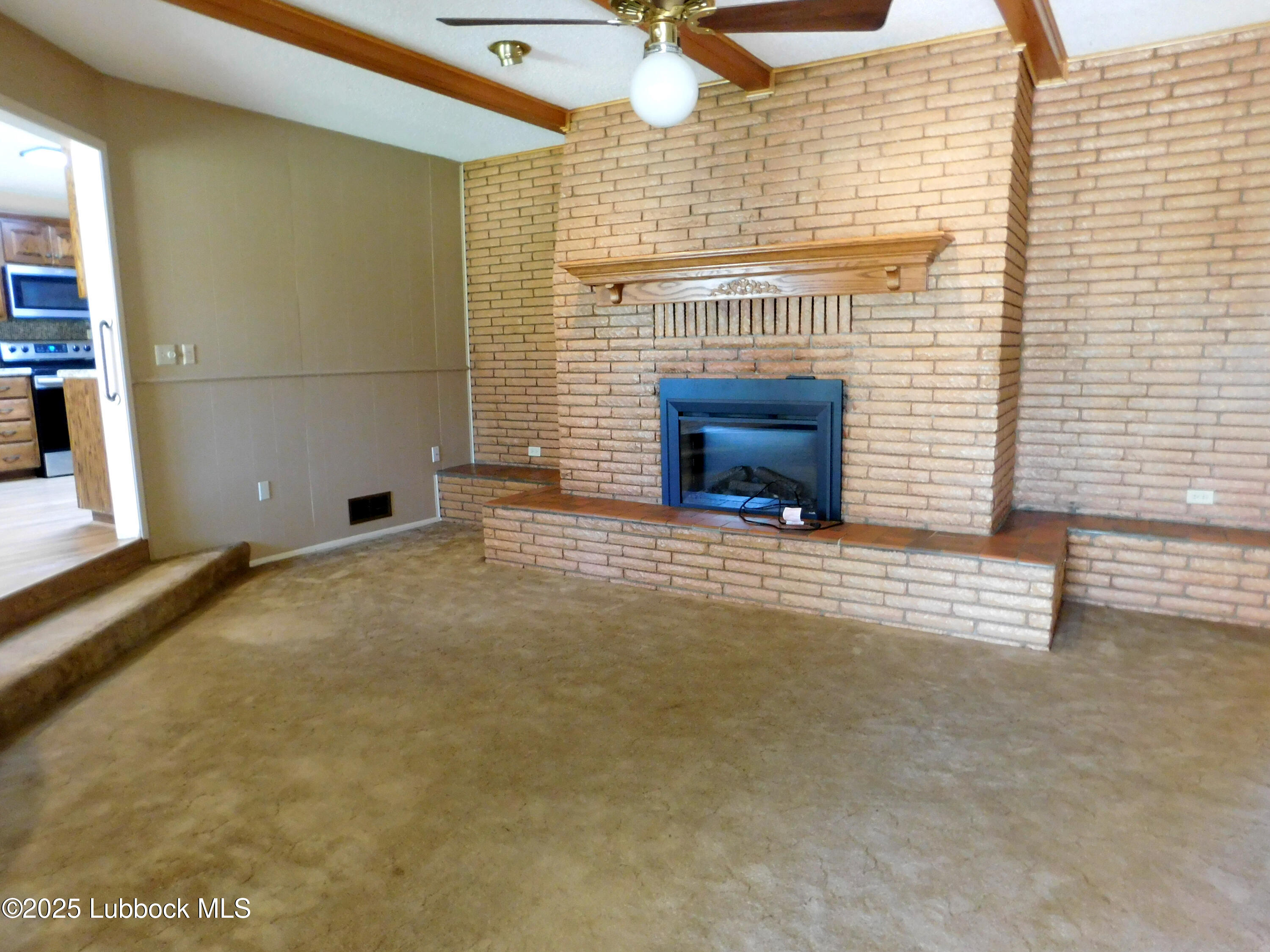 1925 Highway 70 Muleshoe, TX 79347 - Photo 17 of 49 a view of a livingroom with wooden floor and a fireplace