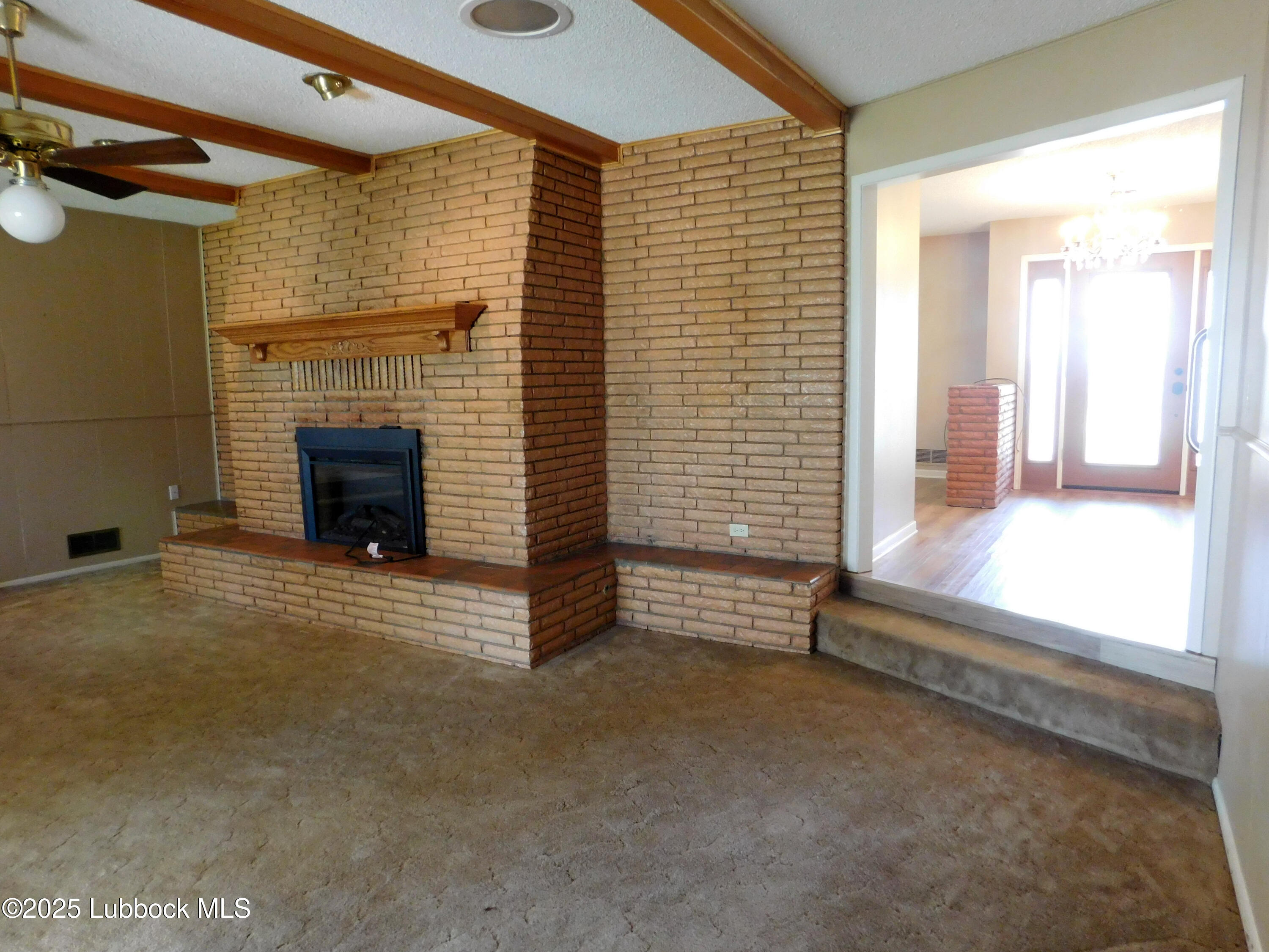 1925 Highway 70 Muleshoe, TX 79347 - Photo 19 of 49 a view of an empty room with a fireplace and a window