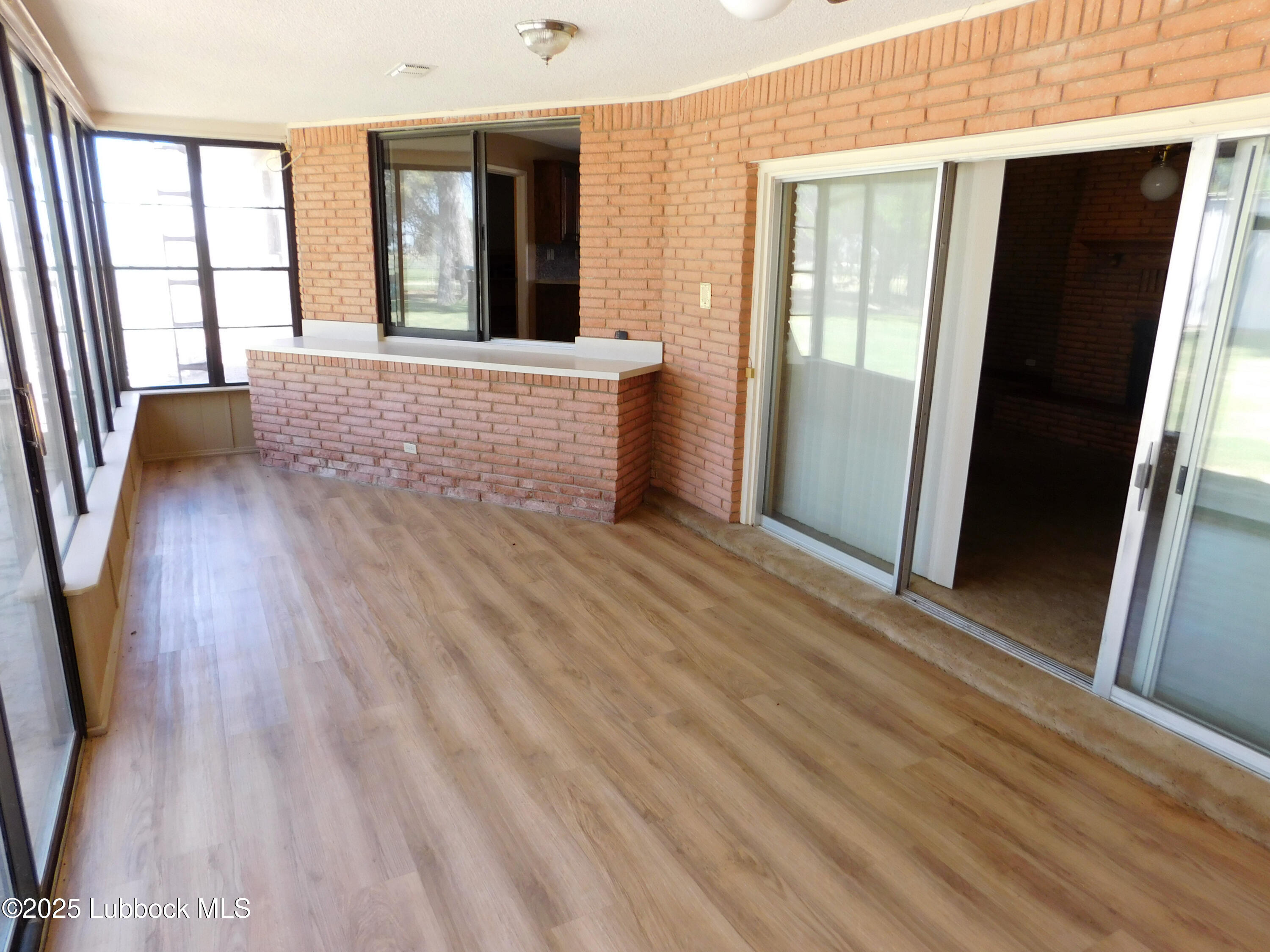 1925 Highway 70 Muleshoe, TX 79347 - Photo 20 of 49 wooden floor and windows in a room