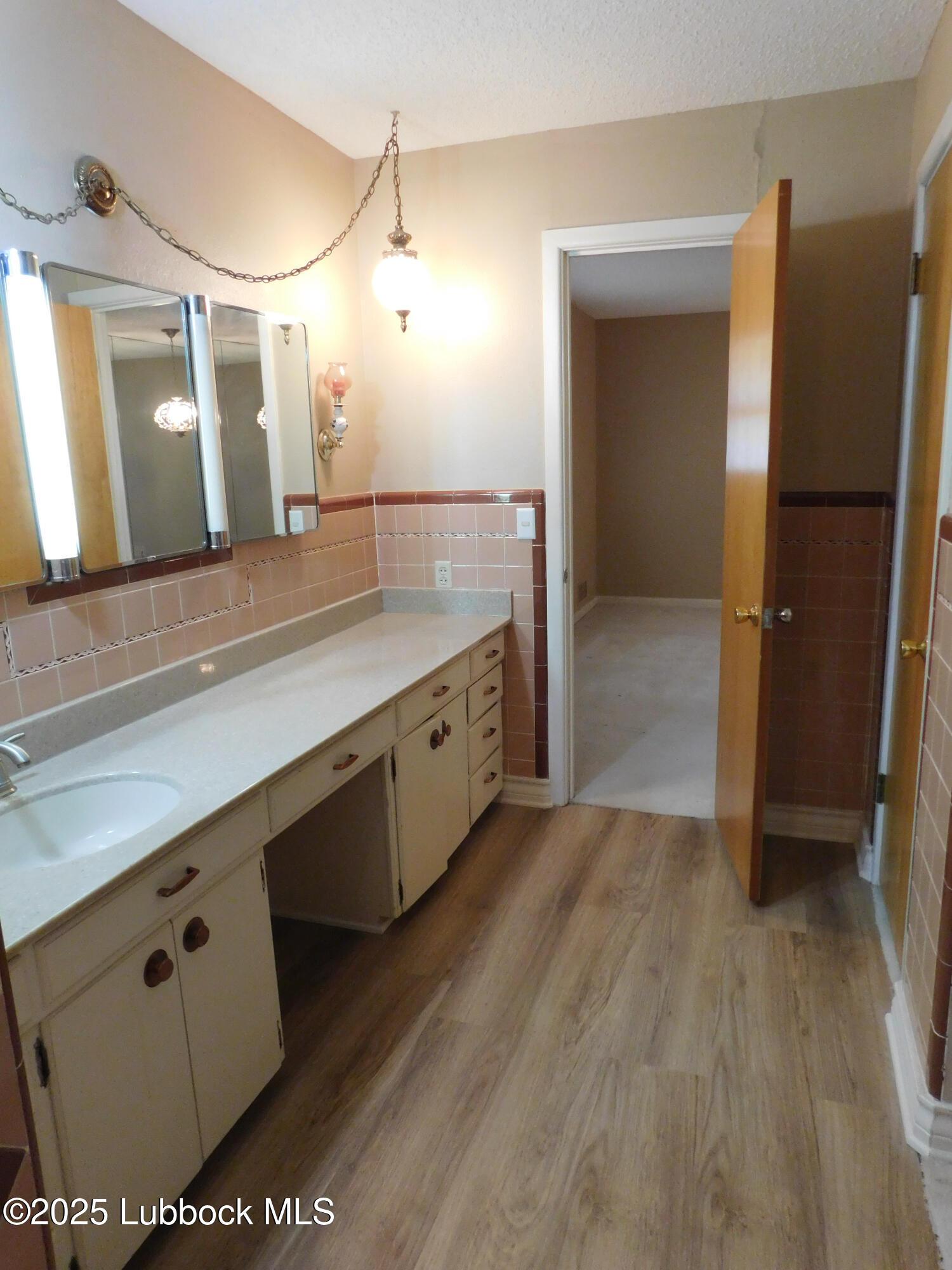 1925 Highway 70 Muleshoe, TX 79347 - Photo 30 of 49 a spacious bathroom with a double vanity sink and mirror